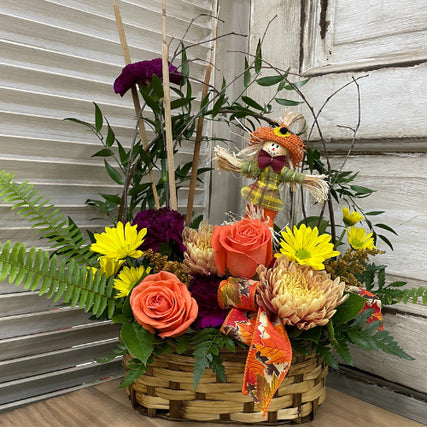 Flower ShopFall Bouquet featuring roses, ferns, and other flowers in a basket arrangement.